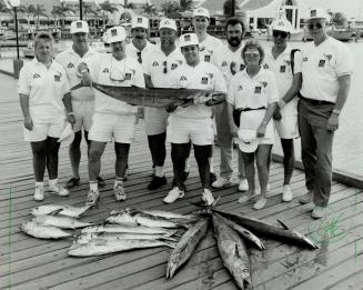 Pick of the Bunch: Don IMcRae, surrounded by fellow Tournament of Champions anglers, holds the tail of his winning catch-of-the-day in Aruba.