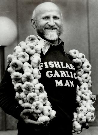 His bud's for you: With a garland of garlic draped round his neck, Ted Maczka - the Fish Lake Garlic Man - extoils the virtues of the aromatic bulb to just about anyone who dares to come near him