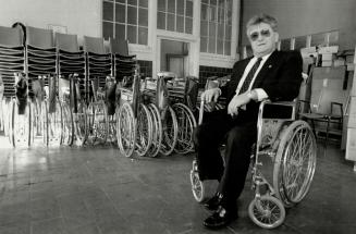 Surplus aid: Bill Magill sits in one of the wheelchairs collected for the Caribbean