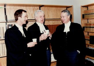Trial recess: Prosecutors, from left, Brendan Evans, Mike Martin and Al MacDonald chat in the law library at the courthouse in St