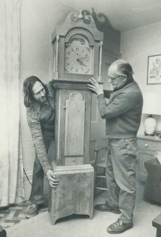 Clockmaker Frank Maw of Buttonville and son Derek examine the grandfather's clock they created with antique wood and a 19th-century design