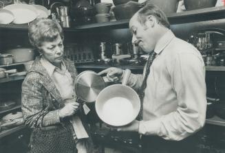 Allan Meinecke discusses merits of cookware with customer Mrs. Hannelore Albercht in his well-stocked Yonge St. store