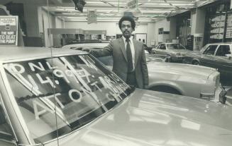 Interest bargain: Sales manager Steven Mengesha stands beside a car at Ontario Chrysler Ltd