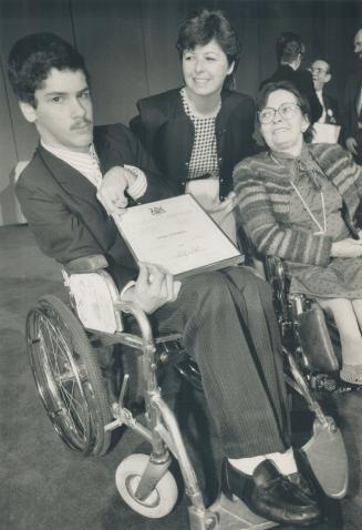 Award winners: Brian Moretton holds the award he received from Shirley Collins, centre, while Mary Ann Brett, another award winner, looks on.