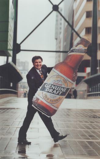 High on Brew: President John Morgan holds up king-size new brew Labatt expects will make headway with public.