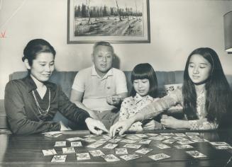 Japanese executive Hiroshi Nakamura, wife Kazuko, daughters, Eiko, Kayoko, right, enjoy out customs.