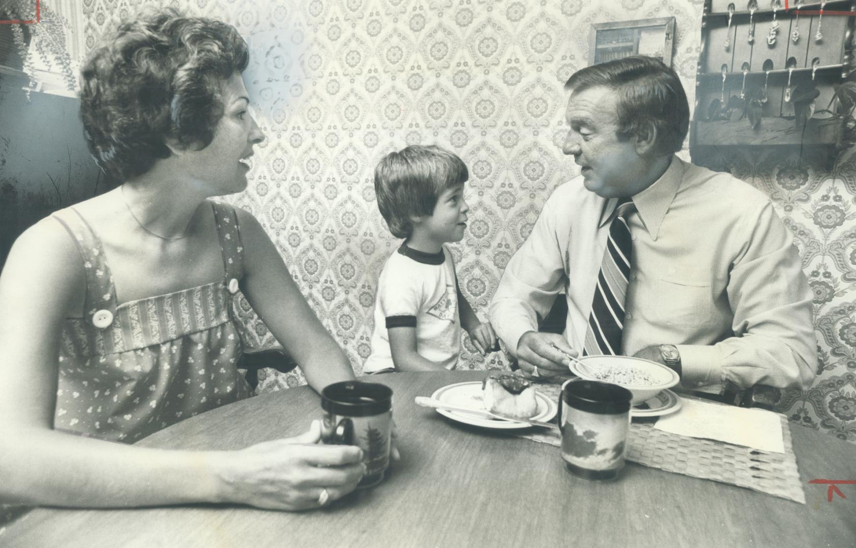 Breakfast get-together: Claude Neon president Heath Matthews relives a Blue Jays baseball game with son Byron, 5, as Sheryl Matthews shares the start of her husband's day over a cup of coffee