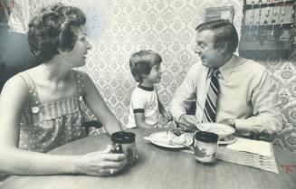 Breakfast get-together: Claude Neon president Heath Matthews relives a Blue Jays baseball game with son Byron, 5, as Sheryl Matthews shares the start of her husband's day over a cup of coffee