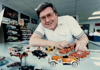 Small treasures: George Maxwell shows off some of the miniature cars he sells through his Unionville company