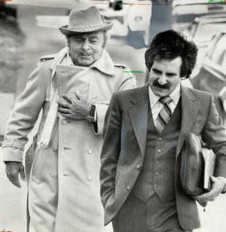 Builder in court Vaughan developer Camillo Milani (left), shown leaving Newmarket court with his lawyer, is facing charges of offering a bribe to a Vaughan councillor