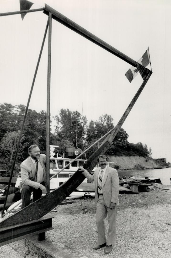 Long-term plans: Mac Makarchuk, left, checks out the keel and bow frame for his 130-foot-long Great Lakes cruise ship being built by Duratug Shipyards Ltd