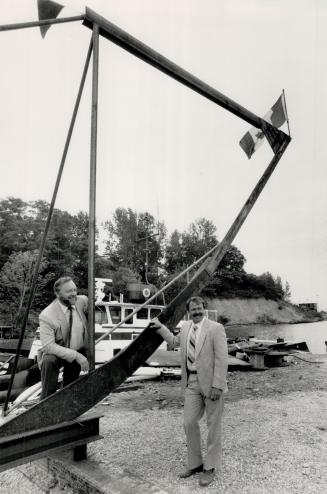 Long-term plans: Mac Makarchuk, left, checks out the keel and bow frame for his 130-foot-long Great Lakes cruise ship being built by Duratug Shipyards Ltd