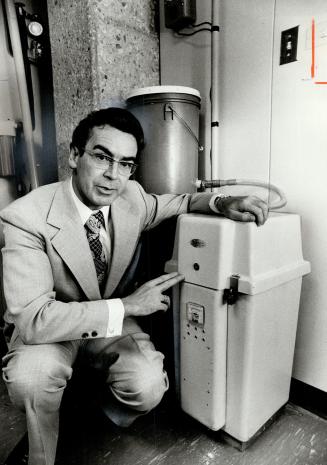 Derrick Morrissey checks silver recovery unit at one of his installations
