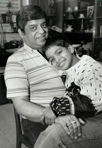 Speaks for others: Sudhanzosu (Mike) Mukherjee, seen with his son Bobby, 7 1/2, lost his job when the inglis plant in Toronto ws shut down.