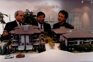 Built for Grandpa: Chris Mullin, above left, Henry Stolp and Brad Warren look over models at Swan Lake Villages in Markham, left.