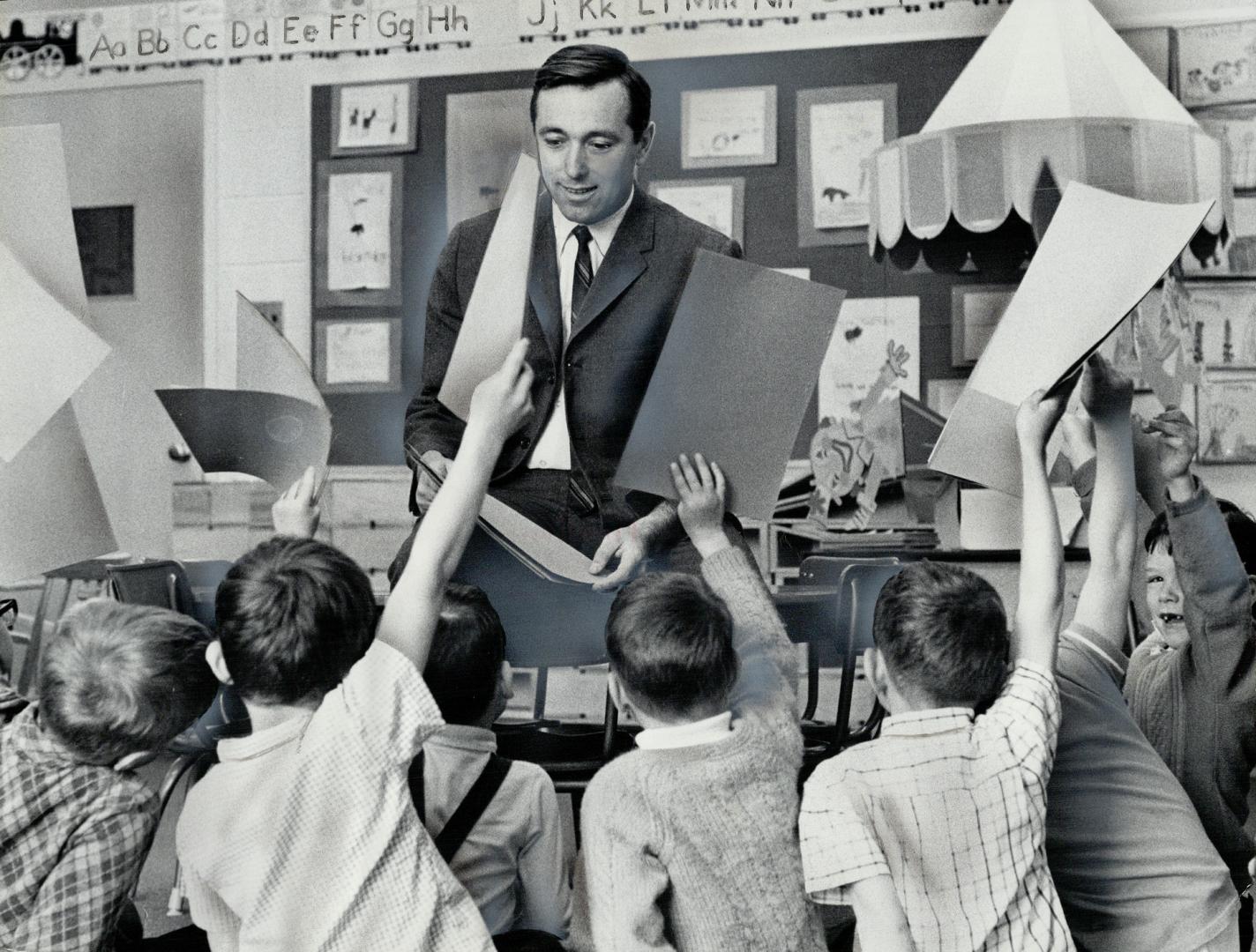 All hands are up as Don Mullin - Ontario's only male kindergarten teacher - conducts a class at Scarborough's St