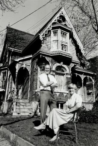 Home: Rollo and Linda Myers sit in front of their Cabbagetown masterpiece. Rollo says renovators should blend designs into existing streetscapes.