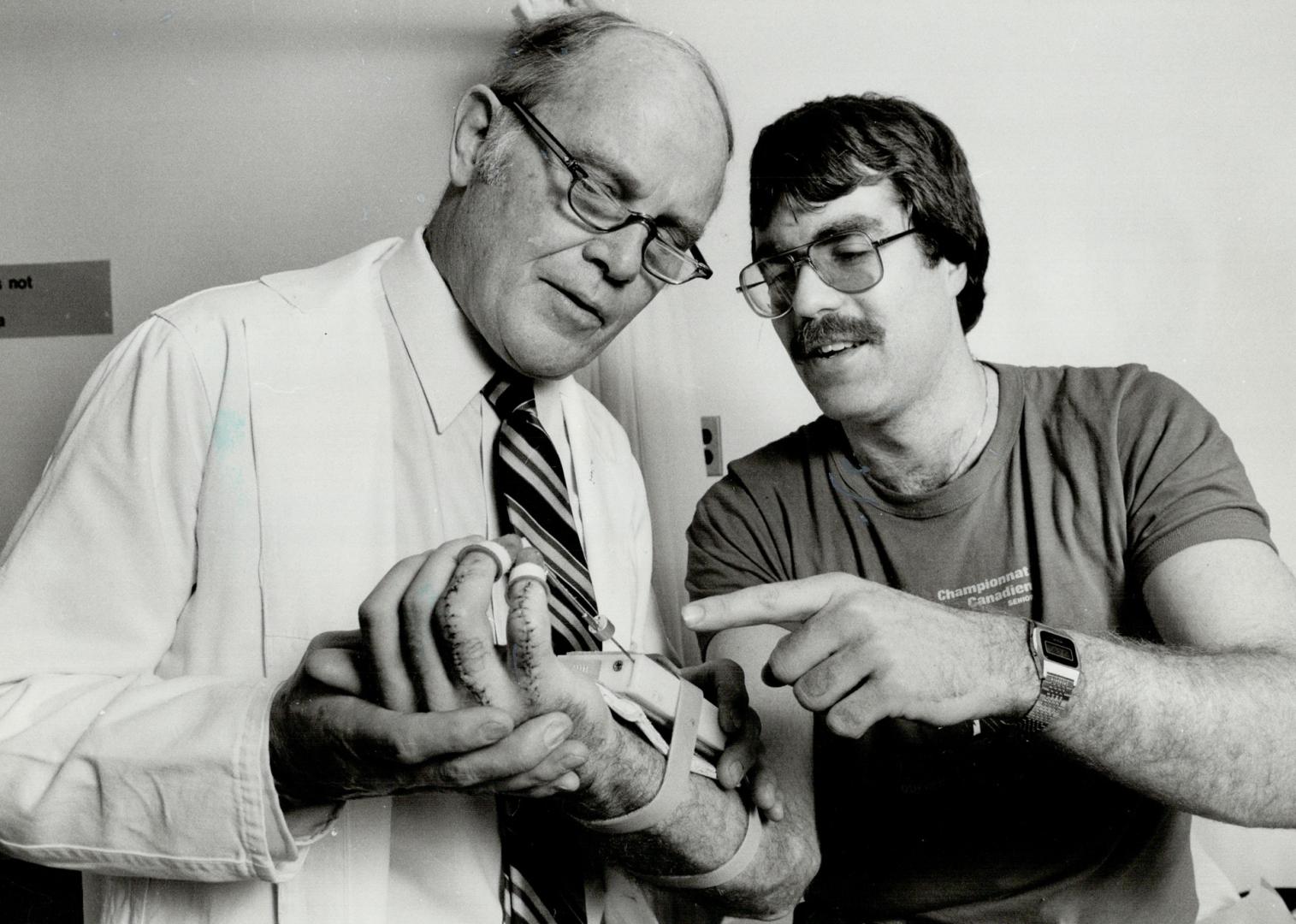 Treating the trauma: Dr. James Murray, head of Sunnybrook Medical Centre's hand unit straps a finger manipluator onto the palm of 23-year-old John Boothby of Orilla. Boothby's right hand was smashed in an car accident in June, 1982. There were 23 different pieces of bone. Says Murray: . . . the hand is such an important part of the body, not just physically but aesthetically.