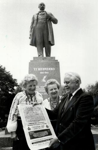 All ready: Micheal Mutzk, an offical of the United Ukrainian Canadaians, his wife, singer Sophia Romanko, and Marge Hunchik (left) are under the watchful eye of peasant-poet Taras Shevchenko in the camp near Palermo, where Ukrainian-Canadians will celebrate tomorrow