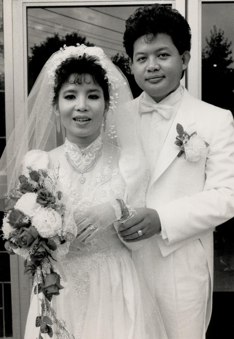 Glittering ceremony: Tham Nguyen poses at her wedding in metro yesterday with Jewels seized last week when groom Sanh Nguyen tried to enter Canada.