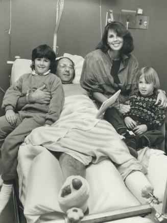 Shooting victim: Jeweller Russell Oliver lies in Mount Sinai Hospital yesterday, recovering from a bullet wound in the foot that he received during a holdup at his Yorkville store on Saturday