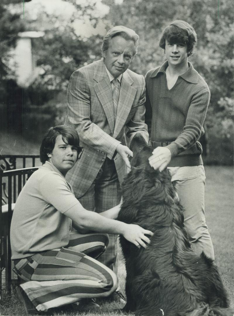 Douglas Omand, director general of the Ontario Science Centre, receives approval from his sons Stephen, aged 13, adn Bruce, 17, for his wool worsted camel glen check suit with single-breasted jacket