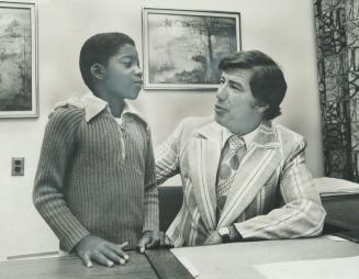 Good student Trevor Phipps, 10, is called into the principal's office to be praised by Gene Page for his improved work