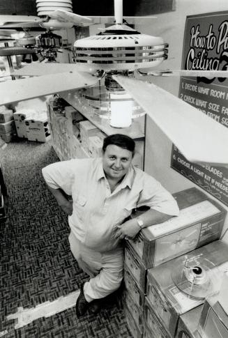 Trendy lighting: Reg Porter stands under Saturn, by Casablanca, one of the new-look ceiling fans he sells at one of his three greater Metro Fan Man stores