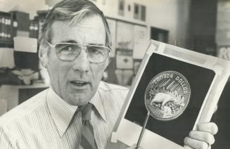 Top dollar: Donald Paterson, a Don Mills graphic designer, displays a drawing of the 1980 silver dollar, which he designed