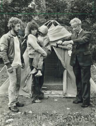 To the rescue: Scarborough Mayor Gus Harris wrings out a pair of socks found in the tent of Linda and George Pearce, who have been camping out for six months while unable to find a home