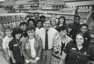 Close-knit team: Pharmacist Barry Phillips (centre) poses with workers at his Shoppers Drug Mart franchise in the Jane-Finch Mall
