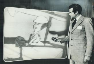 Now that's big: Cartoon character Wilma Flintstone flashes across the color screen as Electrohome president John Pollock operates a remote control to bring in The Flintstones live in a Toronto demonstration