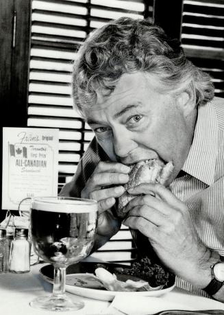 Tasty sandwich: Gene O'Keefe samples his winner of the Great Toronto Food Contest