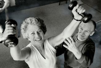 Helping hand: Bus Oliphant, 67, of Oliphant Academy, gives member Shirley Warner instruction on weighttraining program