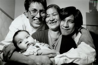 Together at last: Peter Organ, right, is reunited with his mother, Mary Rose Selma, his older brother, Joachim, and baby niece, Evelyn Selma, yesterdy after 20 years