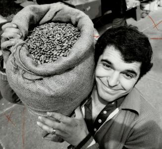 Beans bonanza: A customer (top) picks over the bean bins at Casa Acorean while owner's son John Pavao breaks out a sack.