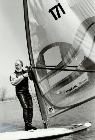 Sailing along: Lloyd Pearce, 81, of Brantford created a sensation when he went wind surfing on Lake Ontario the other day