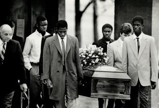 Last respects: Teammates from Richard Persaud's high school basketball team carry the casket bearing his ashes to a waiting hearse