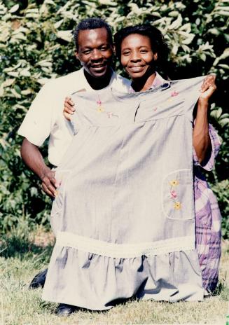 Trying to help: Jesumond and Wiladine Pierrilus hold up a handmade dress created at the Haut Saint Marc Mission in Haiti