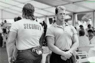 No entry: Pat Plishka, left, a former centre with the Toronto Argonauts, and Dean Peruzzi control access to a VIP tent operated by a racing team sponsor