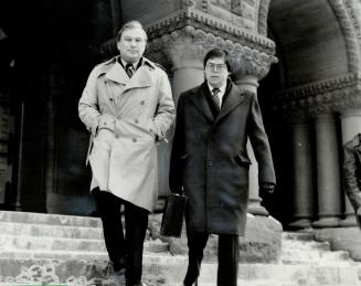 Lawyer charged: Joseph Pomerant (left), charged in connection with the alleged misappropriation of $500,000 belonging to a client, leaves court todya with his counsel Morris Manning