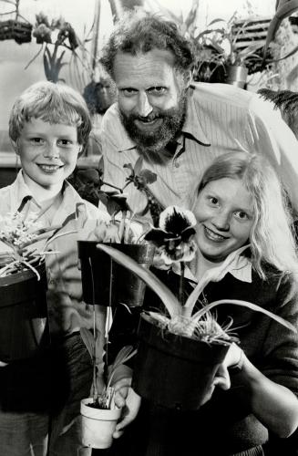 Growing hobby: Peter Poot, Scarborough's deputy planning commissioner, and children, Eric, 9, and Sonja, 14, look over some of the orchids the Poots grow at their farm at Goodwood