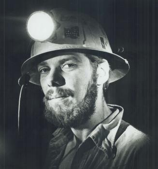 Closeup of Don wearing miner's helmet with light.