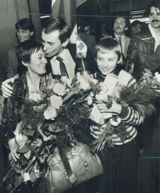 Poles reunited in Canada, Stephen Przybyiski greets his wife Wiesia with a kiss while his son Marcin smiles happily during ar tion reunion at Toronto International Airport last night