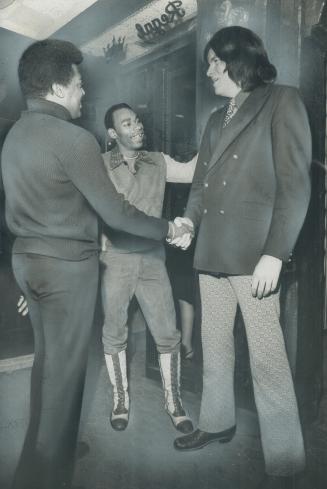 Reverend Bouncer David Rayner--he's the big one --greets singer Edwin Starr (left) and drummer Jim Mack, of entertainment group of Coq d'Or Tavern on Yonge St