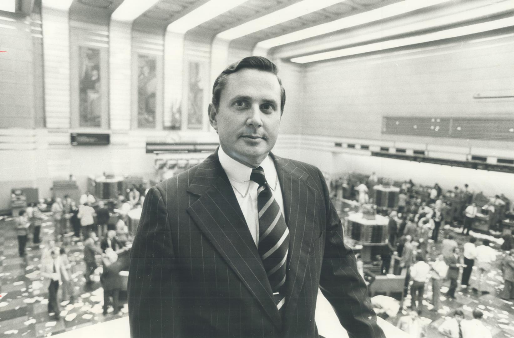 James D. Robinson III, chairman of New York based American Express Co., pictured at the Toronto Stock Exchange where his company's shares were listed for the first time yesterday. The firm is currently facing a challenge to its domination of the travellers' cheque market from Visa and Master Charge, whose credit cards dominate the international bank card scene. Master Charge hopes to be in the business by next May and Visa will make a decision shortly.