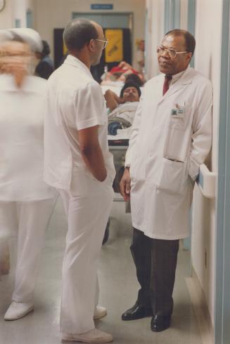 Color Barrier: Prestigious teaching hospitals are largely closed to people like himself, says obstetrician Dr. Francis Sam, right, talking with nursing attendant George Maingot at Doctors Hospital.
