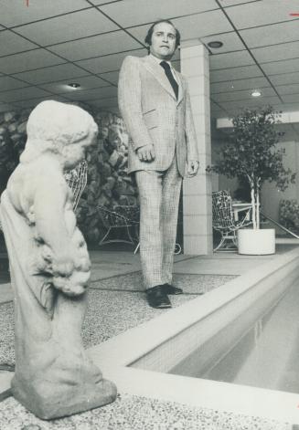 Frank Sanelli, president of Sanelli Pools Ltd., models suit with notched lapels and flared pants.
