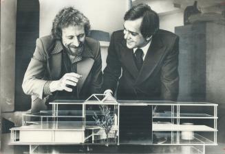 Jerry Sans (right), owner of the Quorum club, talks over a model of the establishment with designer Jerry Adamson
