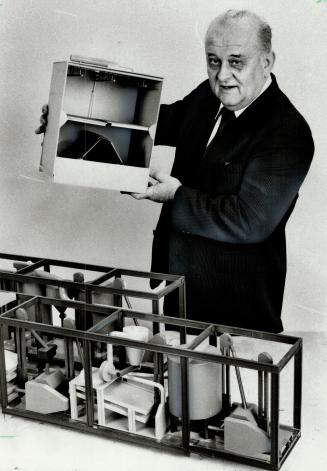 A hill of beans: Donald Prazmowski displays a model of his soy bean oil extracting invention.